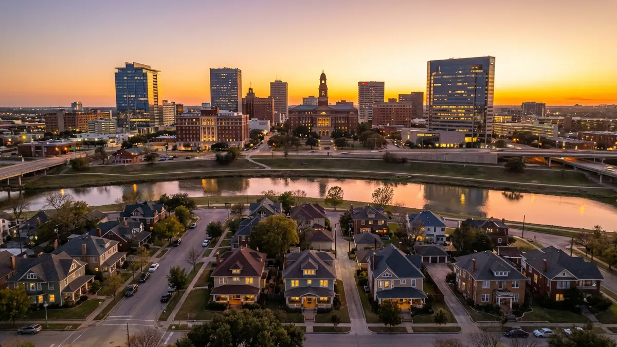 Cinematic aerial view of Fort Worth skyline at golden hour, 16:9 aspect ratio. Foreground shows charming historic homes in Near Southside neighborhood with tree-lined streets. Middle ground features the Trinity River reflecting sunset colors. Background includes downtown high-rises with warm interior lighting. Ultra HD 8k resolution with crisp details on architectural textures - brick facades, wrought iron details, and modern glass towers. Shallow depth of field blurs distant traffic on I-30 slightly, conveying movement.