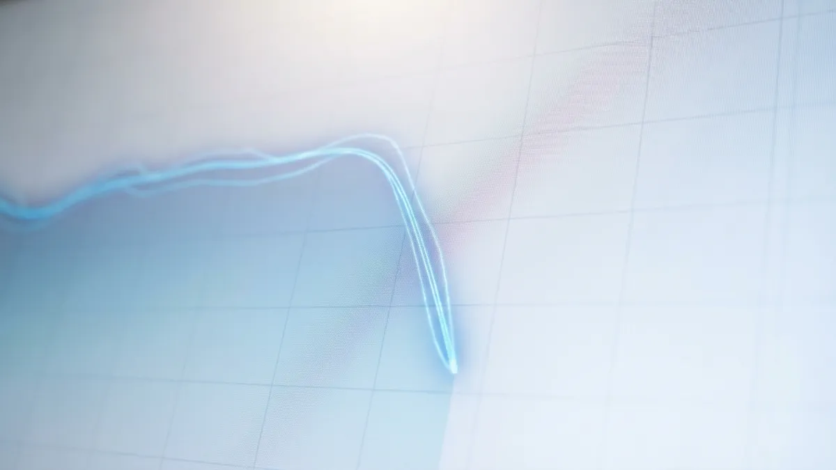 Close-up of a digital real estate market graph displaying a slight downward trend for 'Plano Spring 2026' on a minimalist blue and white background. The graph lines are subtly shimmering. Soft, diffused overhead lighting, 16:9 aspect ratio, highly detailed 8k.