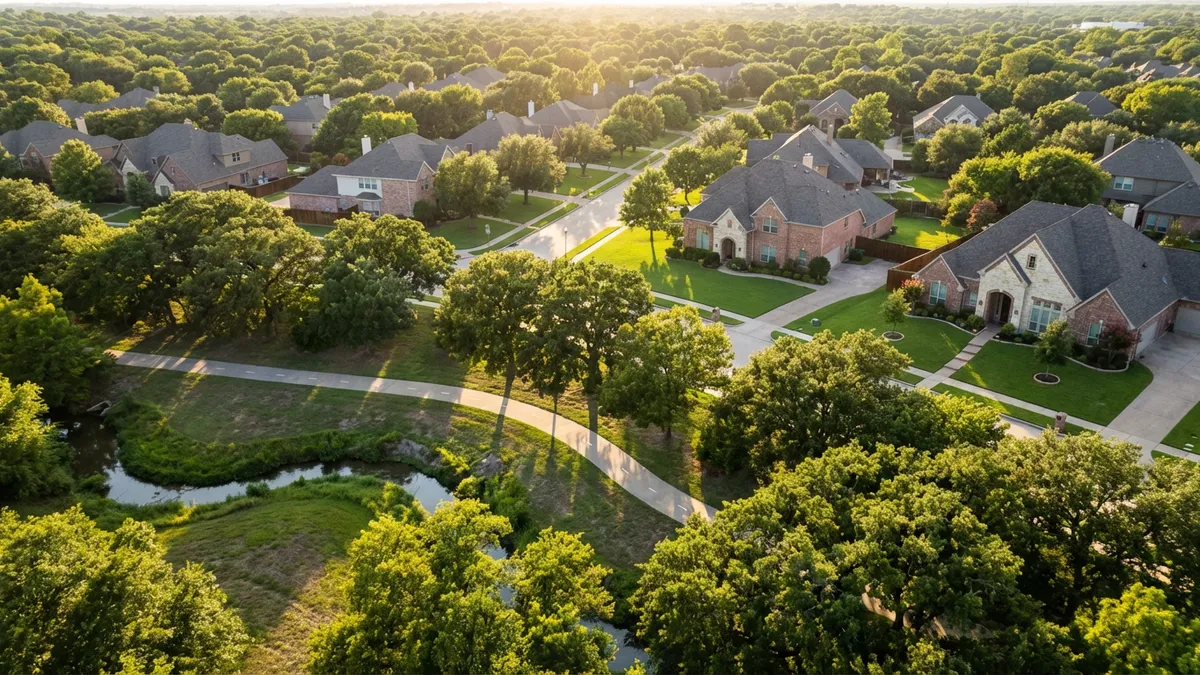 Overhead view through mature tree canopy of a clean suburban street in Richardson, Texas. Sunlight dappling on manicured lawns and brick homes. A bike path winds through a park in the foreground with a creek. Bright, clear, golden hour light. Highly detailed, cinematic, 16:9 aspect ratio, 8k.